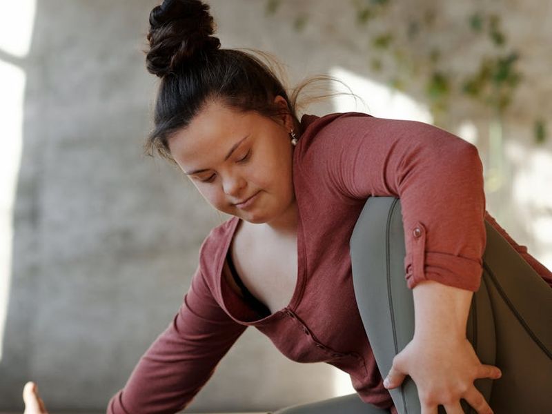 Person practicing yoga flow in a bright room.