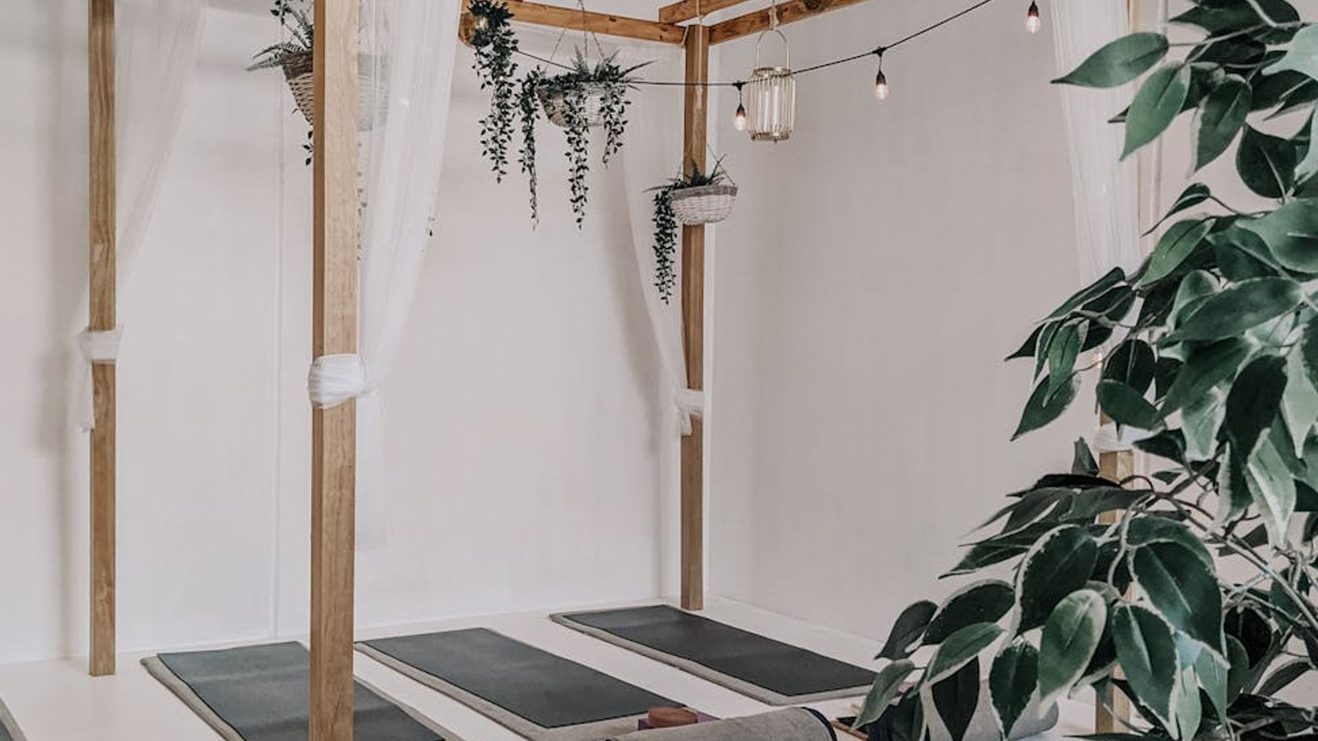 Serene yoga studio with natural light and minimalist decor.